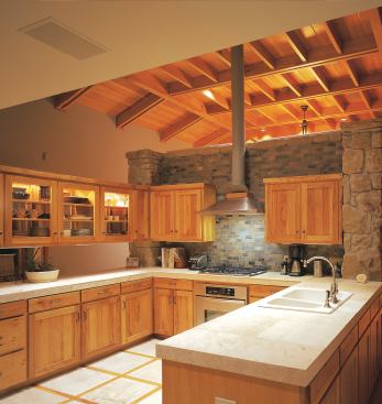 Non-structural walls separate the kitchen, family room, and living and dining area. The stone dividers keep the home’s scale from feeling overwhelming while still allowing light and air to flow through the interiors.