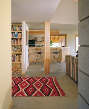 Concrete floors, open shelving, simple trim, and strictly conventional construction helped bring the cost of this custom home down to tract-house territory.