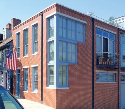 Proportion and materials tie the new modern façade to its historic neighborhood. 