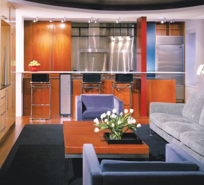 A pair of pillars and a breakfast bar are all that separate the kitchen and living room, creating a strong relationship between the two spaces.