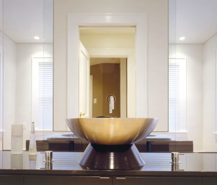 A slightly dropped ceiling panel visually defines and separates the bathing area.