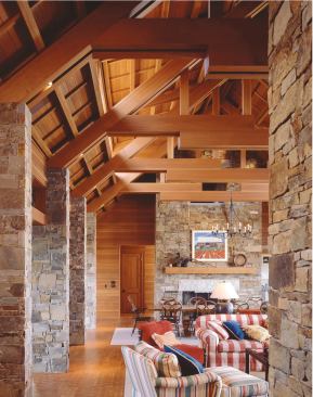 Clear Douglas fir roof framing caps the great room in dramatic fashion. Fir wall paneling, fir ceilings, and endgrain fir block flooring give this large house an all-of-apiece feeling.