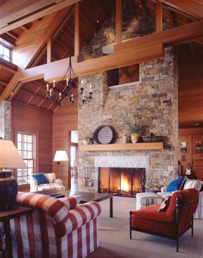Twin opposing shed dormers lighten the voluminous roof of the great room. The chimney “window” gives the second-floor loft a view of the public space below.