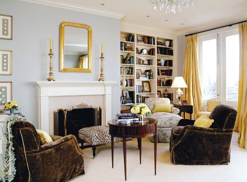 The master bedroom fireplace lends a comfortable scale to the high-ceilinged space.