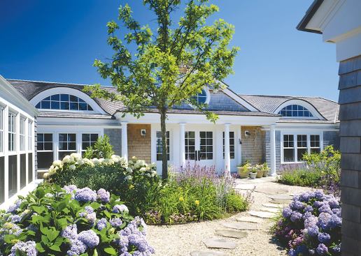 The front façade and guest wing meet to create an entry courtyard landscaped by Kris Horiuchi.