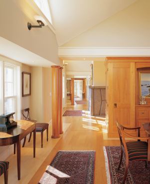 Rather than full-blown walls, a series of freestanding cherry cabinetry pieces divides the major rooms. 