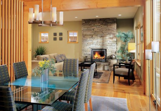 Like many a Norwegian bachelor farmer, though, this house has a rich and sophisticated inner life, with exposed timber framing, clear-finish millwork, and a pair of massive bluestone fireplaces tempering a classic Modernist plan.