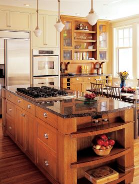 The Craftsman-influenced island and hutch were inspired by features original to the house, which dates from the 1920s. Executed in quartersawn white oak, their furniture-like design contrasts with the painted cabinets in the rest of the kitchen.