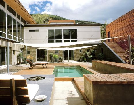 Although a level above, the main living spaces contain easy access to the courtyard through two sets of stairs at either end of the L-shaped footprint. From the living room a staircase descends directly into a casual lounge that acts as the hub for winter entertaining. The kitchen opens to the exterior stair.