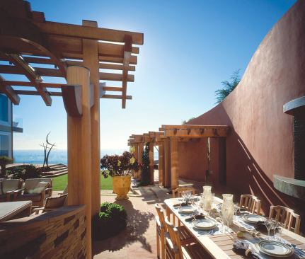 Set in a densely developed beachfront location, the garden needed privacy screening. That's provided by a serpentine stucco wall that shelters and shapes the backyard.