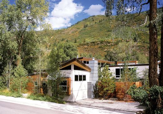 From the restrained street elevation there are no telltale signs of the outdoor oasis just beyond the board-formed concrete and Hardipanel walls. Indigenous plantings help the home all but disappear into its scenic mountain backdrop.