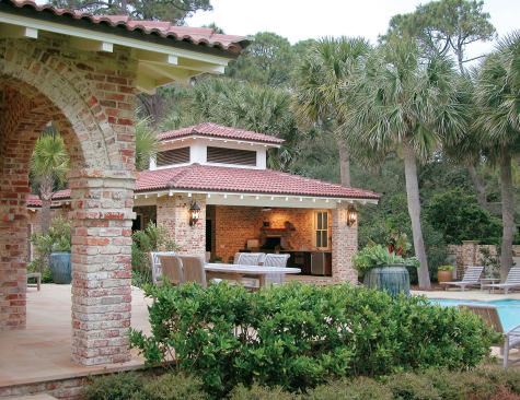 Landscape architect Jerry Spencer chose plants that could withstand salt spray and would create a subtropical look. His palette included hibiscus, split leaf philodendron, crinum lily, white African lily, and sego and fan palms. For the pool house, he planted native cabbage palms to frame the view.