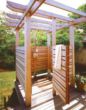The cedar shower shares a south-facing deck with the mud room of this Martha's Vineyard house. A trellis connects the shower to the house, creating a little gateway to the house and deck.