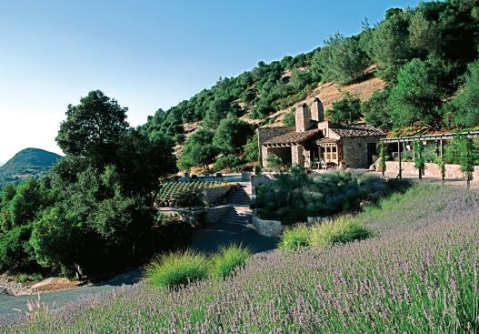 Designed for outdoor living, this 1,200-square-foot Tuscan-style residence opens almost completely to its outdoor spaces. 