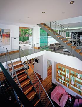 An oversize stair opening visually connects first- and second-floor living spaces. 