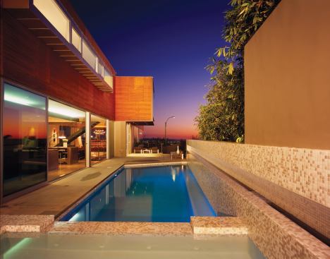 A garden wall conceals the pool area and main entrance.
