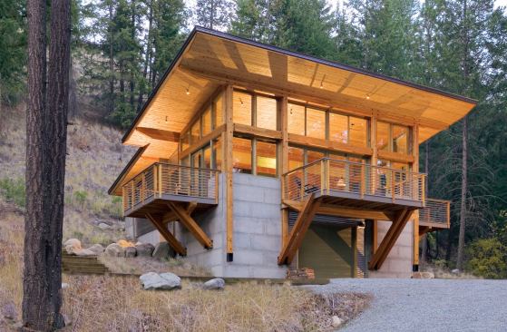 The homeowners won't feel boxed in by this cabin’s spacious glass box of a living area, which delivers views, protects from the weather, and captures the sun’s light and warmth.