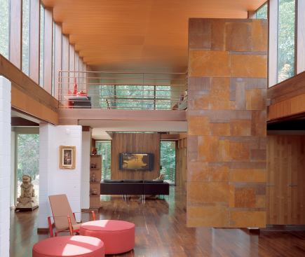 Rich interior materials such as walnut, cherry, and aged steel give the space a sense of warmth.