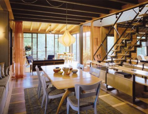 The kitchen segues into the dining area and sun room beyond.