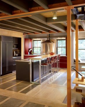 Subtle details like stainless toekicks, full-length cabinet hardware, and a splash of color on the cooking station give a refined feel to the utilitarian space.