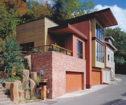 A mix of salvaged bricks and cedar siding clads both the guest house and the main house.