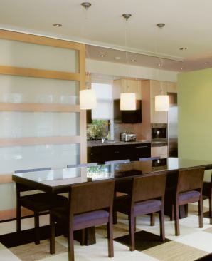 A sliding glass-and-wood door shuts the dining room off from the kitchen to create a more formal space when the occasion calls for it.