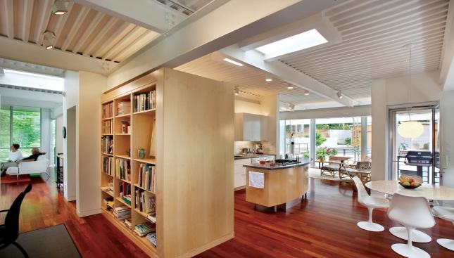 Cabinet walls and partitions stop short of the main level ceiling, distinguishing functional areas without isolating them.