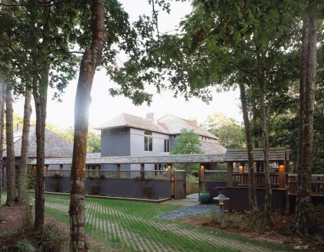 Gridded concrete pavers (above) let grass grow through the driveway and parking area for a more natural look and permeability.