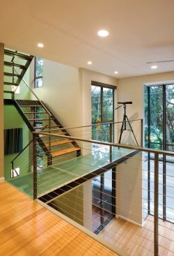 Vertically oriented volumes and multistory glazed openings give this contemporary row house a feeling of spaciousness out of proportion to its actual size.