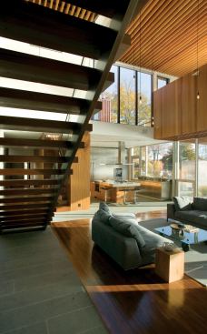 An exposed system of thin plywood floor joists suggests the pattern of tree rings.