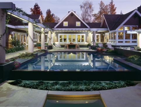 To heighten the reflective qualities of the pool and spa, devices like filters and skimmers were placed far below the surface so that the water remains still most of the time. Using a medium dark-gray plaster finish also sharpens the pool’s reflection.