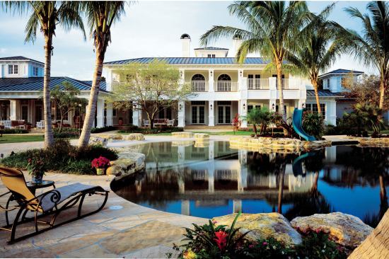 The beach entry to this pool provides a safe place for children to play in the water, while strategically placed rocks offer natural seating at the pool's edge.