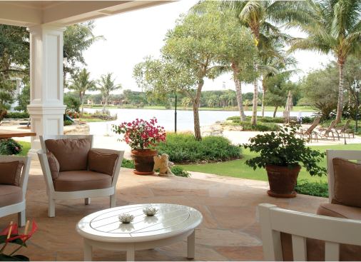 From the home's covered terraces pool and lake blend into one watery scene.