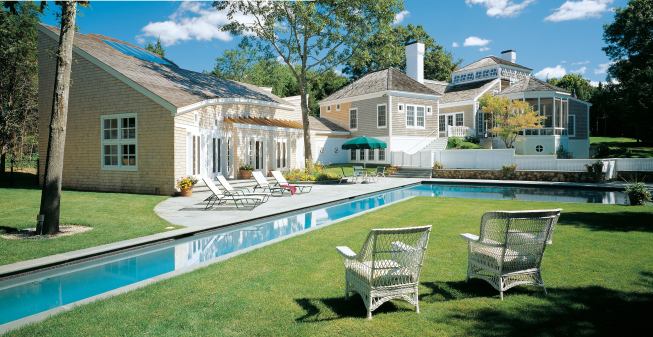 Landscape architect Jennifer Jones took advantage of the site's irregular grades to create interesting terraces and to frame views. "The lap lane gives a very strong visual direction toward the woods," says Jones. "We expanded the lawn around the end of the lap pool and used native trees and shrubs to hide the required fence while improving the transition from landscaped lawns into natural woods." “