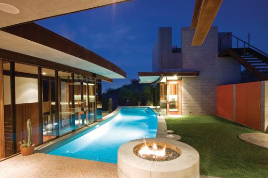Installers cut the 12-inch mats into bendable strips that follow the pool's curves.