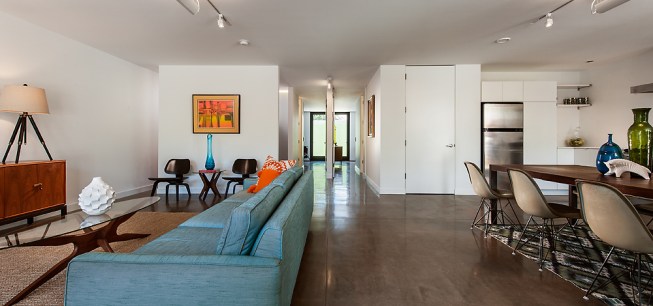 Interiors are based on an open plan to maximize space and reduce building costs. One splurge were the floor-to-ceiling frameless doors for the few enclosed rooms. 