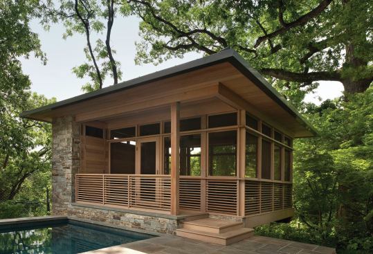 The screened bluestone-and-cedar pavilion serves as both a pool house and an open-air living room.