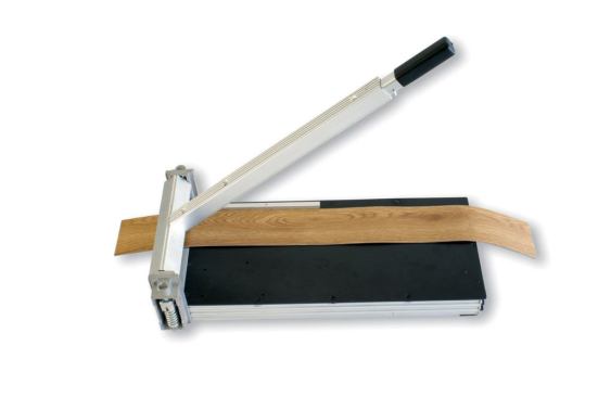Cutinator  Keep your saws for cutting laminate or engineered wood floors. The Cutinator does not generate noise or dust, and it’s portable and ready for use anywhere. Plus, it does not require power—just elbow grease. This version weighs 17 pounds and cuts cork tiles, vinyl flooring, vinyl composite tile, and rubber. 
www.cutinator.com.