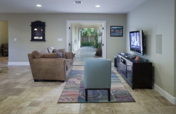 Travertine tile extends from the living room out onto the lanai to create a flowing indoor-outdoor space.