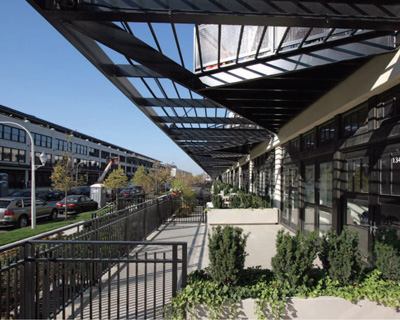As is so often the case, the façades' most animating feature grew out of programmatic and landmark-status constraints. The distinctive triangular balconies —which add roughly 100 square feet of precious outdoor space to each unit—are integrated into an open grid mimicking the covered canopy that once protected the dockworkers and produce.