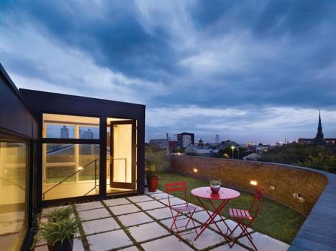 Clad in anthracite zinc, the master suite is 4 feet lower than the roof terrace.
