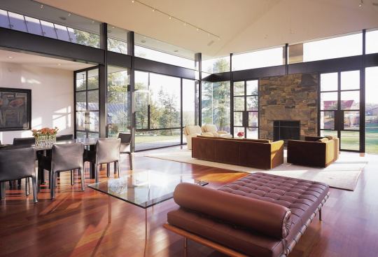 Massive steel beams and double-glazed glass protect against the wind that whips around the living room walls. In nicer weather, French doors and operable windows permit the owners to transform the space into an almost-outdoor room. For more information on this project,
click here.