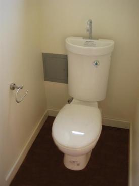 The Caroma dual-flush toilet has an integral sink. Water used for hand washing drains into the tank for use in the next flush.