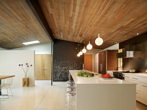Architect John DeForest opened up the public areas into a roomy kitchen and dining space while moving the living room to a more private and cozy location.