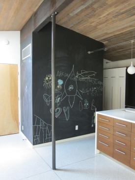 A chalkboard wall wraps around the new mudroom and pantry, which connects to the garage.