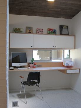 A built-in desk serves as homework center, computer station, and sewing space. This work station is partially open to the kitchen so the family can all be in the same space while doing separate activities.