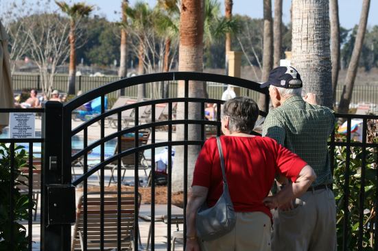 A couple peeks into the giant pool area at Stone Creek which offers access to residents only.