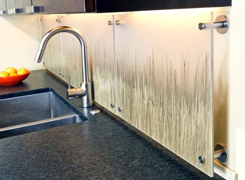 3Form resin panels inlaid with natural grasses provide an organic counterbalance to the clean lines of this Arlington, Va., kitchen by Landis Construction. And unlike your typical configuration, they aren’t flush with the wall. “We set the panels off the wall so we could backlight them as an alternative to traditional under-cabinet lighting,” explains project designer Greg Gardner. “This light source introduces a soft glow and accentuates the grass pattern on the panels.” 
www.landisconstruction.com