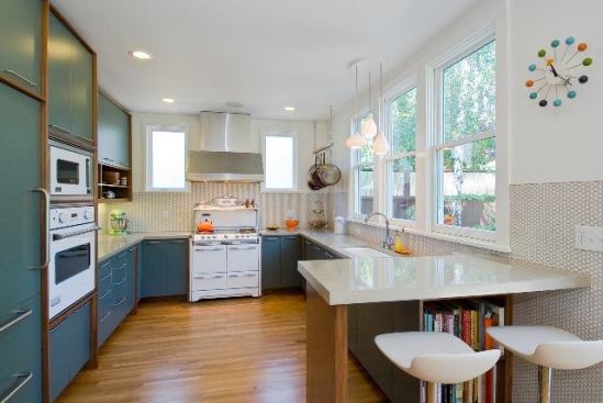 Designer Maxi Lilley went with Modwalls ModDotz porcelain penny round tiles in Marshmallow with a medium gray grout to provide a light and punchy texture to this wrap-around backsplash wall in her century-old Craftsman bungalow in Oakland, Calif. The retro tiles complement a 1957 O'Keefe & Merritt stove and a fresh combo of walnut and laminate cabinets. The porcelain dots measure 18mm and come mesh-mounted on 11.9" x 11.5" sheets. 
http://lilleyfaurot.com