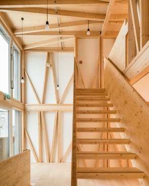 Prefabricated timber frame modules construct the upper floors of DFAB House in Dübendorf, Switzerland, by ETH Zurich.